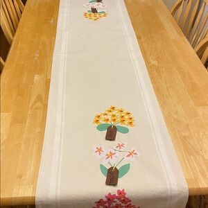 Floral Printed Table Runner w tags that say Love grows here & embroided flowers